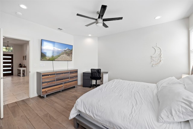 bedroom with ceiling fan and light wood-type flooring