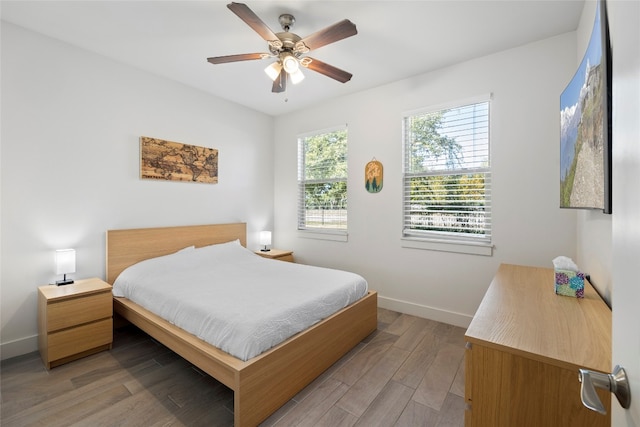 bedroom with light wood-type flooring and ceiling fan