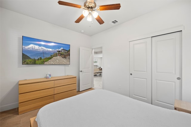 bedroom featuring ceiling fan, hardwood / wood-style flooring, and a closet