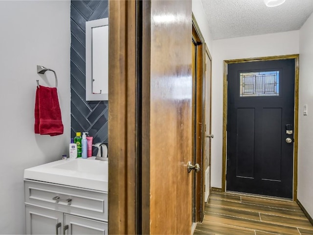 interior space featuring vanity and a textured ceiling