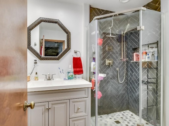 bathroom featuring vanity and an enclosed shower