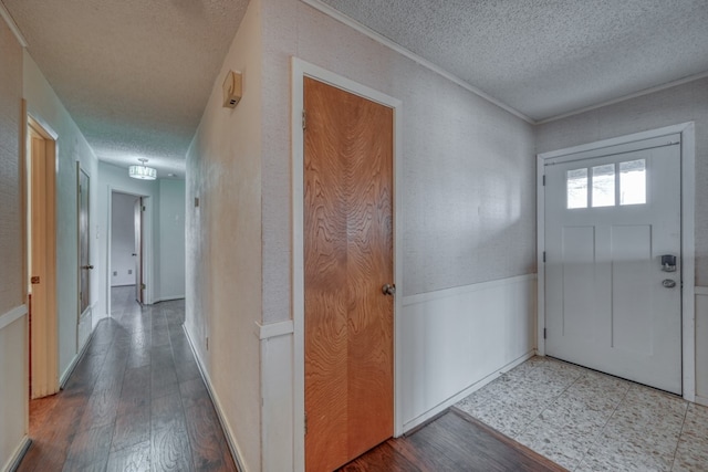 foyer with wood-type flooring and a textured ceiling