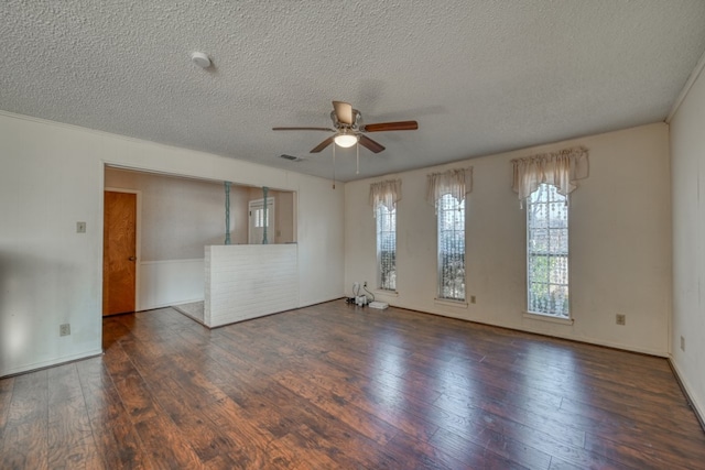 spare room with a textured ceiling, ceiling fan, and dark wood-type flooring