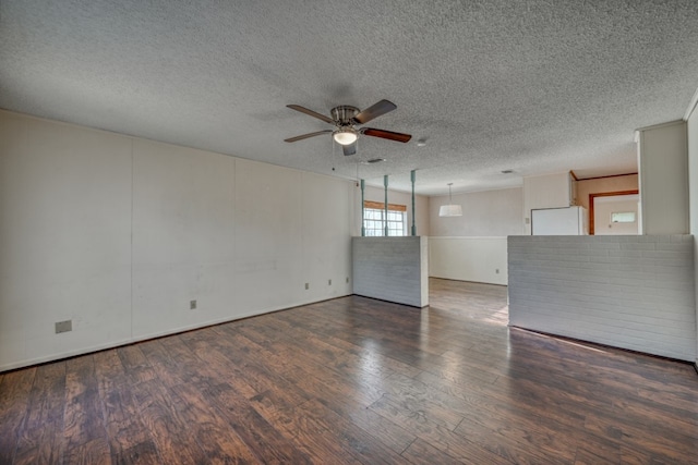 unfurnished room featuring a textured ceiling, ceiling fan, and dark hardwood / wood-style floors