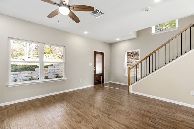 entryway with ceiling fan and dark wood-type flooring