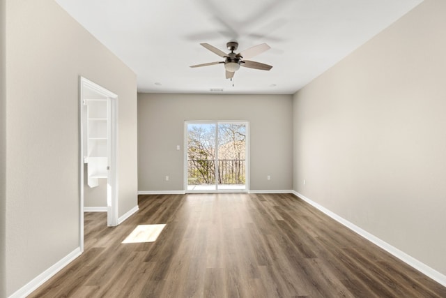 empty room featuring ceiling fan and dark hardwood / wood-style floors