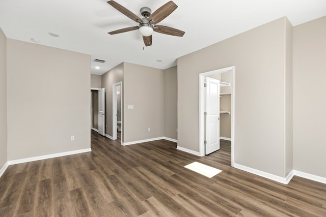 empty room featuring ceiling fan and dark wood-type flooring