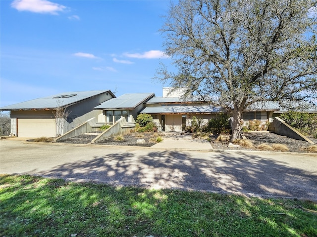 view of front of property featuring a garage and solar panels