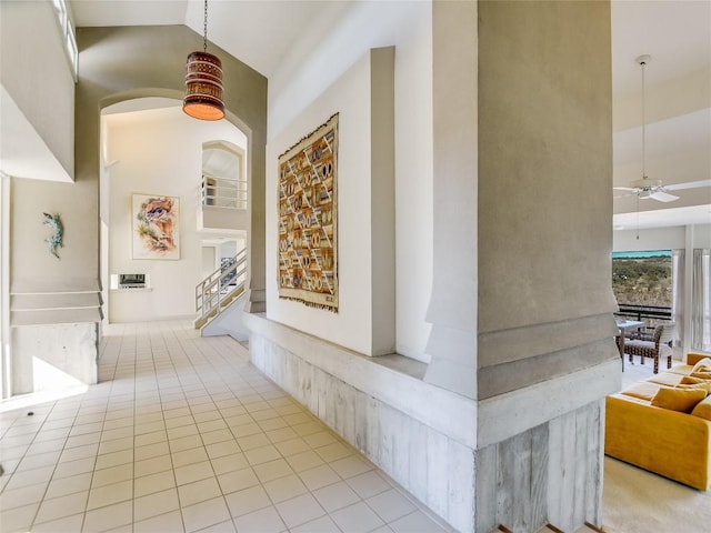 hall with light tile patterned floors and vaulted ceiling