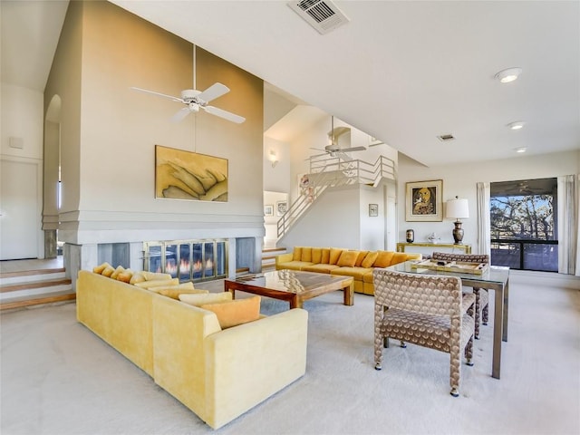 carpeted living room featuring high vaulted ceiling