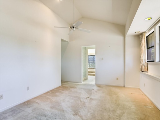 carpeted empty room with ceiling fan and lofted ceiling