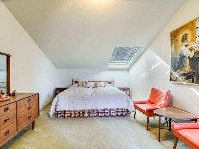 carpeted bedroom featuring vaulted ceiling with skylight