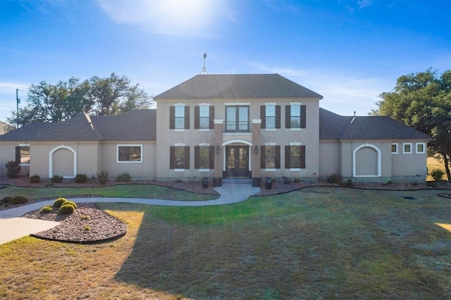 view of front of property featuring a front yard and stucco siding