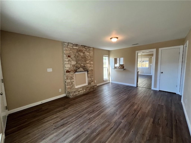 unfurnished living room featuring a fireplace and dark hardwood / wood-style flooring