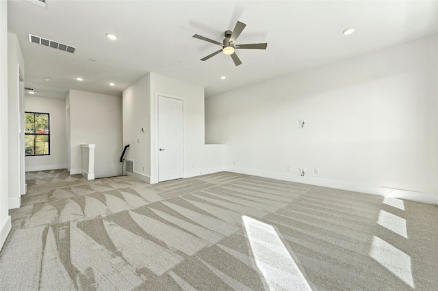 unfurnished living room with ceiling fan and light colored carpet