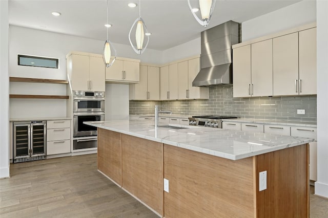 kitchen with decorative backsplash, wall chimney range hood, light wood-type flooring, and beverage cooler