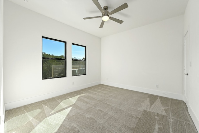 empty room with ceiling fan and light colored carpet