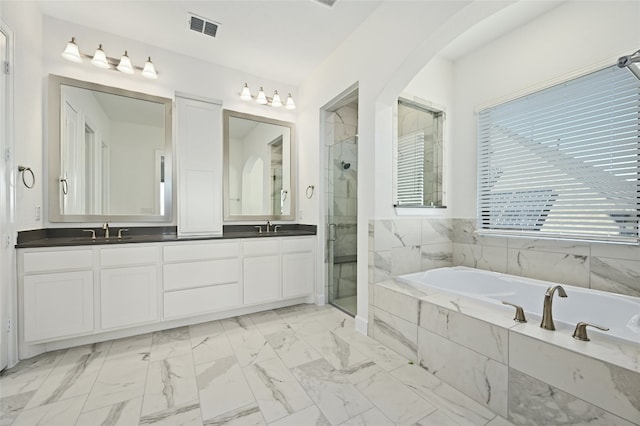 bathroom with tile patterned floors, plus walk in shower, and double vanity