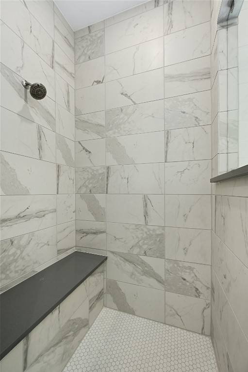 bathroom with a tile shower