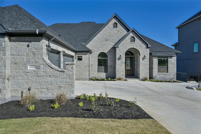 french country home featuring a garage