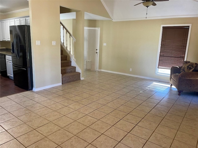 interior space with tile flooring, ceiling fan, and crown molding