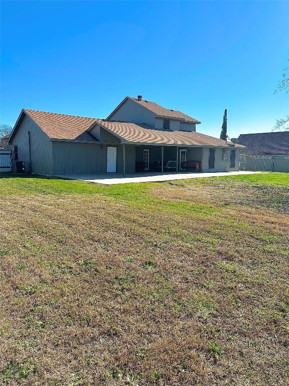 rear view of house with a patio area and a yard