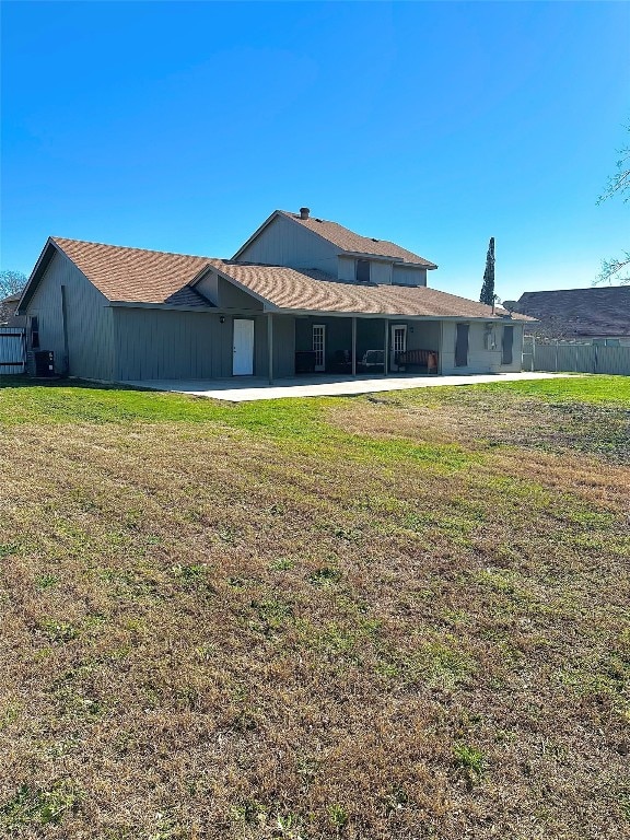 back of property featuring a yard and a patio area