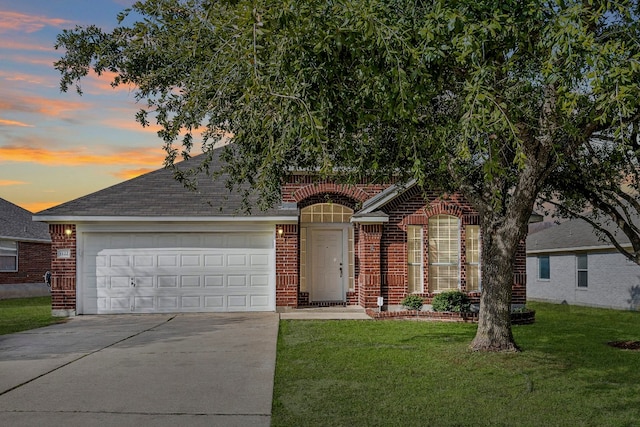 view of front facade featuring a garage and a yard