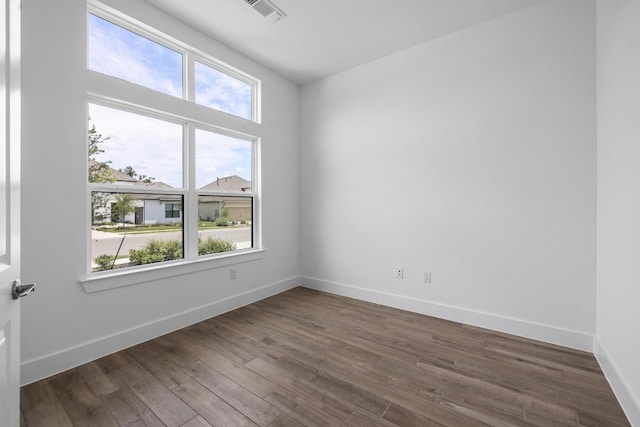 empty room featuring hardwood / wood-style floors and plenty of natural light