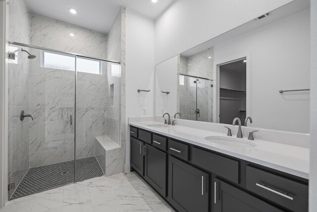 bathroom featuring double sink vanity, walk in shower, and tile patterned floors