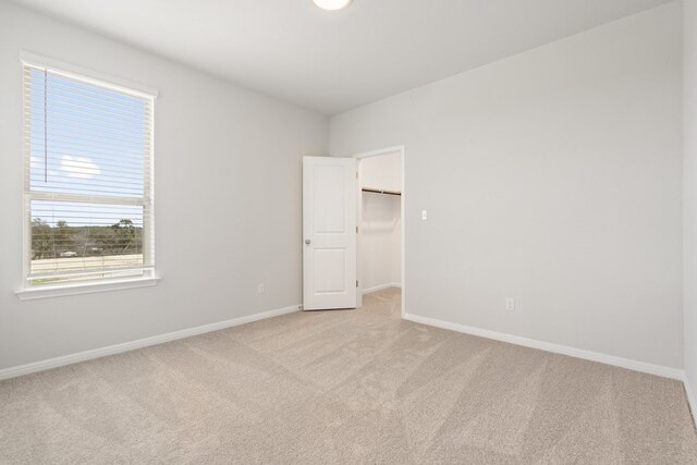 unfurnished room featuring light colored carpet