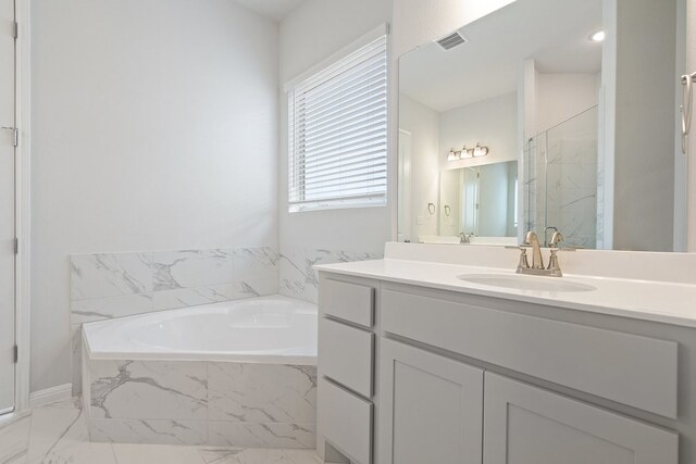 bathroom featuring vanity and shower with separate bathtub