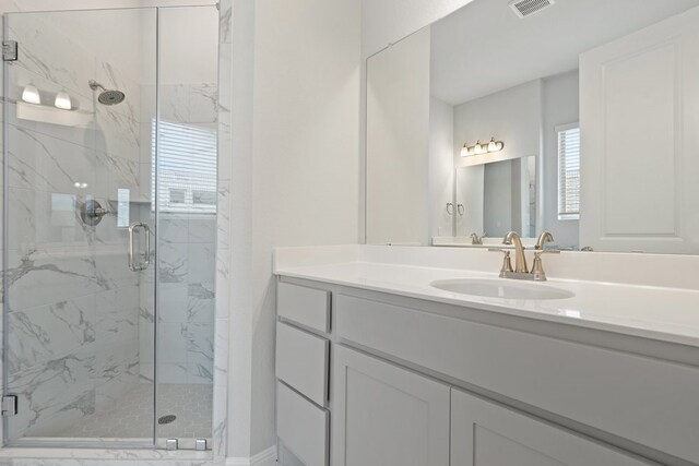 bathroom with vanity and an enclosed shower