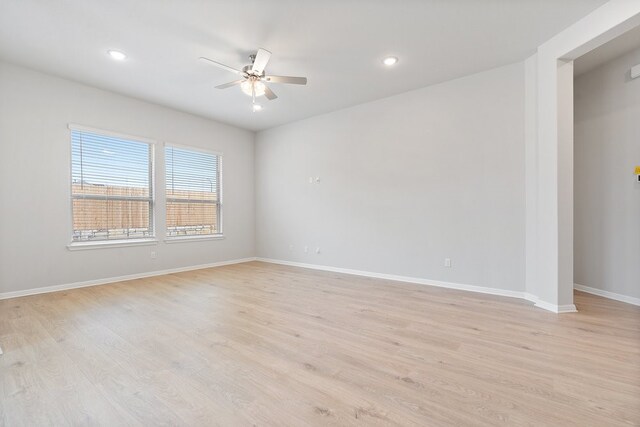 spare room with ceiling fan and light wood-type flooring