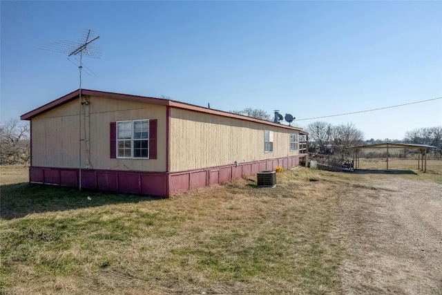 view of property exterior featuring a lawn and central AC unit