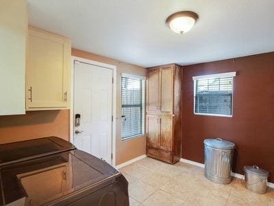 interior space with light tile patterned floors and washing machine and clothes dryer