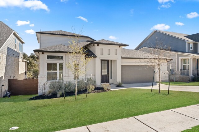 prairie-style house featuring a front yard and a garage