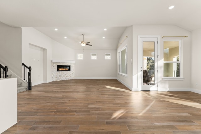 unfurnished living room featuring hardwood / wood-style flooring, ceiling fan, and lofted ceiling