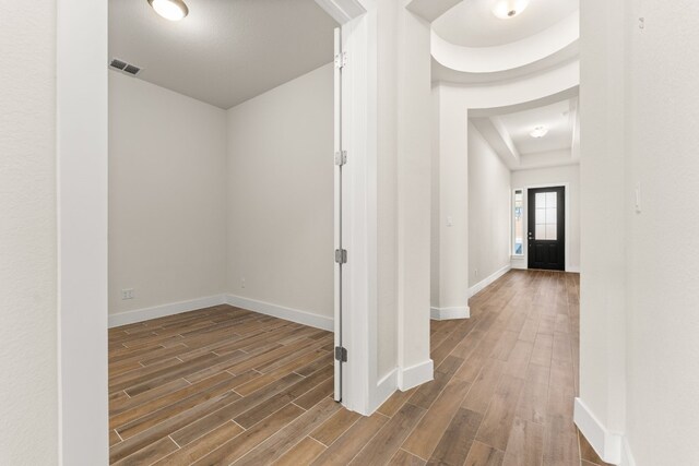 hall with wood-type flooring