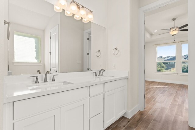 bathroom featuring ceiling fan, hardwood / wood-style floors, vanity, and lofted ceiling