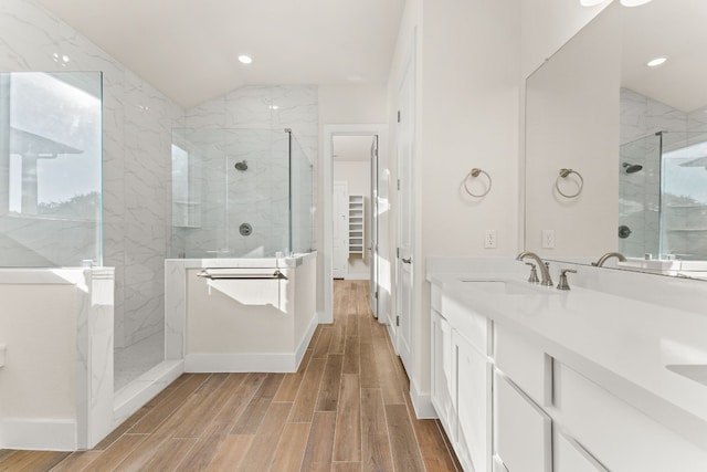 full bath featuring wood tiled floor, a sink, lofted ceiling, and walk in shower