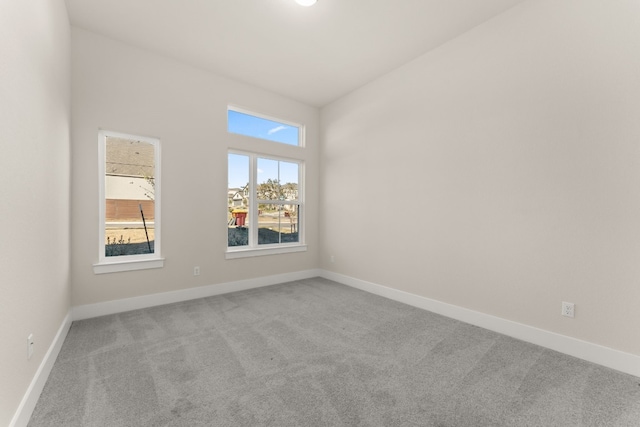 spare room with carpet floors and baseboards