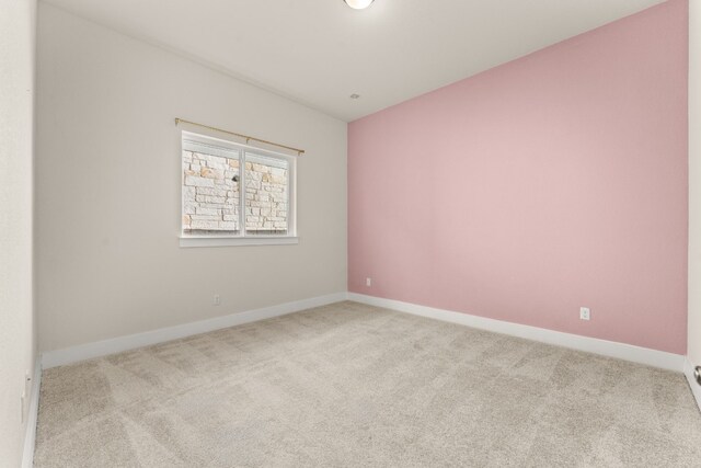 unfurnished room with baseboards and carpet flooring