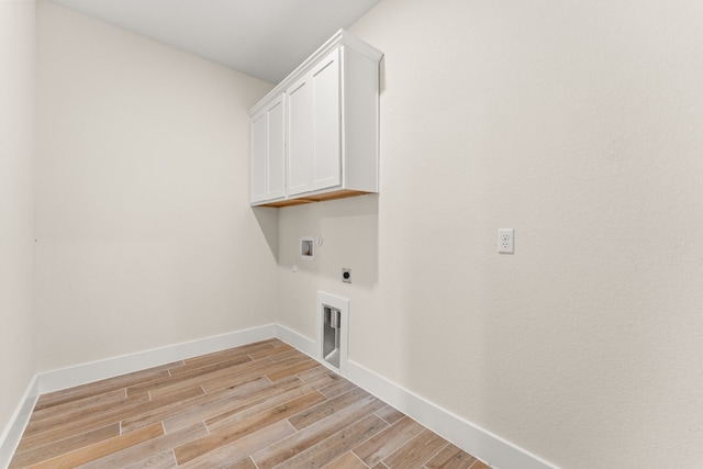 laundry area featuring hookup for an electric dryer, cabinets, washer hookup, and light wood-type flooring