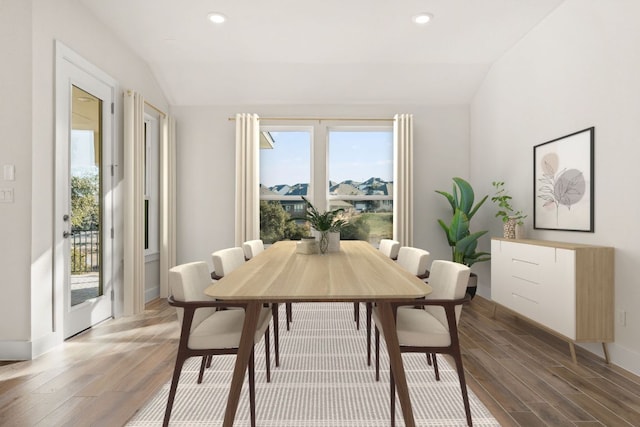 dining room featuring lofted ceiling, plenty of natural light, light wood-style flooring, and recessed lighting