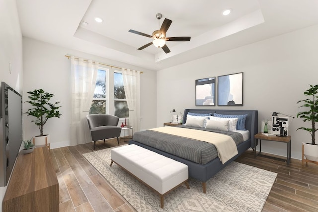 bedroom with recessed lighting, baseboards, a raised ceiling, and wood finish floors