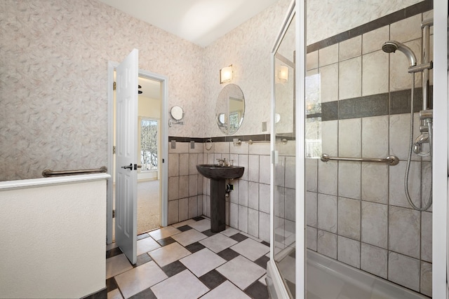 bathroom featuring tile walls and tiled shower