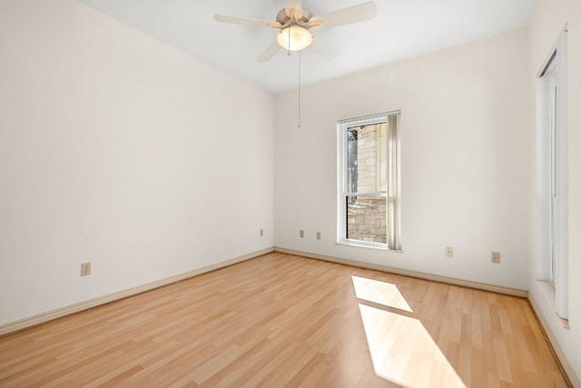 spare room featuring ceiling fan and light hardwood / wood-style flooring