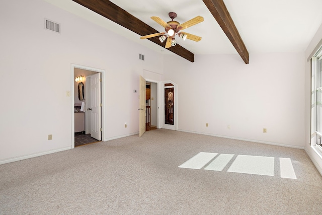 unfurnished bedroom with ceiling fan, light colored carpet, ensuite bath, and lofted ceiling with beams