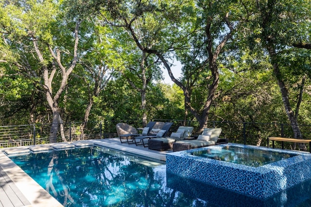 view of swimming pool featuring an in ground hot tub